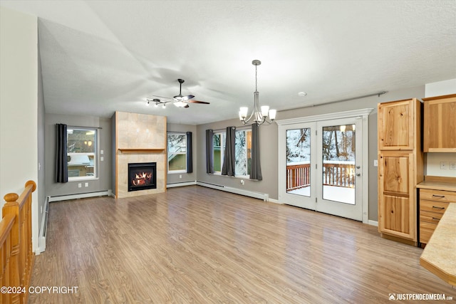 unfurnished living room with a healthy amount of sunlight, light hardwood / wood-style floors, and a fireplace