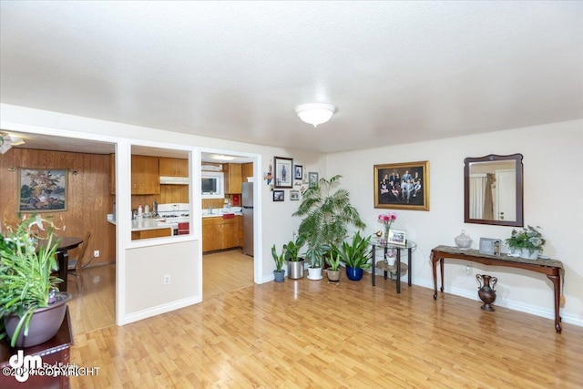 misc room with a textured ceiling and light wood-type flooring