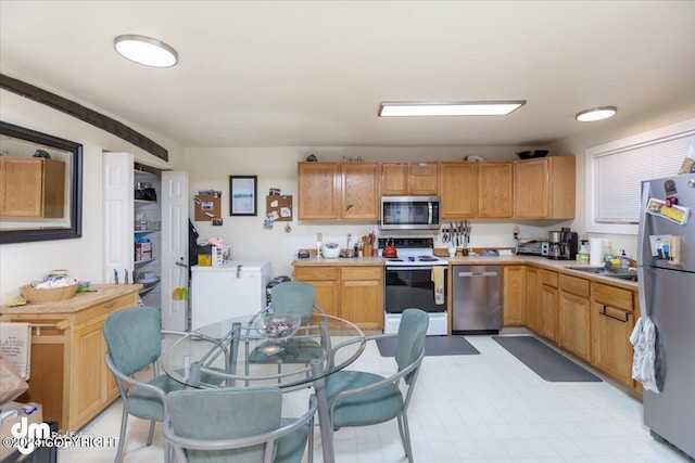 kitchen featuring appliances with stainless steel finishes and sink