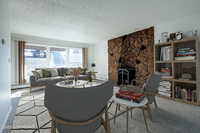 carpeted living room with a textured ceiling, a wood stove, and baseboard heating