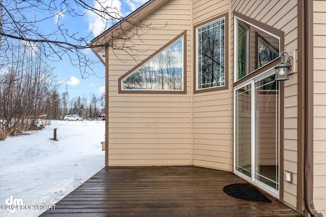 snow covered property featuring a deck