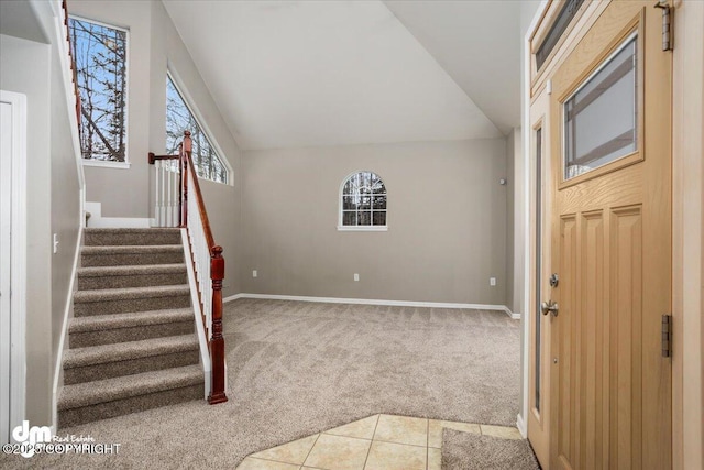 entrance foyer featuring lofted ceiling and light colored carpet