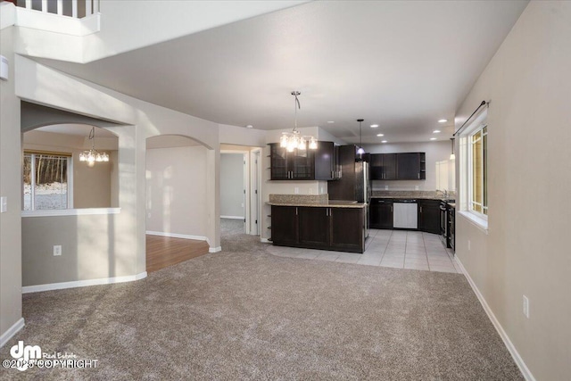 kitchen with dishwasher, light colored carpet, and an inviting chandelier