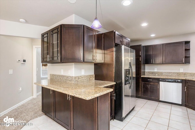 kitchen featuring light stone counters, dark brown cabinets, appliances with stainless steel finishes, and hanging light fixtures