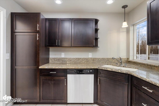 kitchen featuring sink, dark brown cabinets, light stone counters, decorative light fixtures, and stainless steel dishwasher