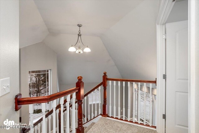 staircase with vaulted ceiling and a chandelier