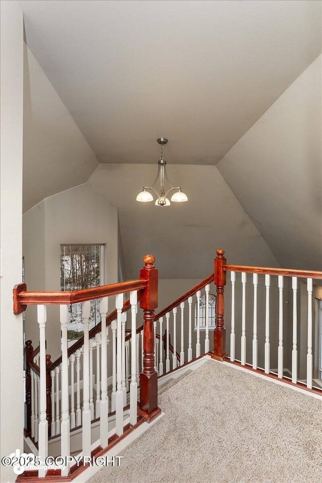 stairs featuring lofted ceiling, a notable chandelier, and carpet