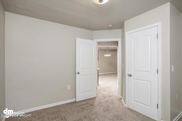 spare room featuring light colored carpet