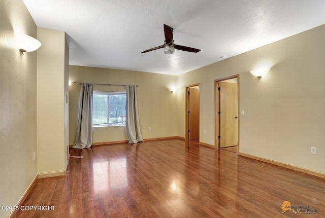 empty room featuring hardwood / wood-style floors and ceiling fan