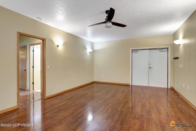 unfurnished bedroom featuring dark hardwood / wood-style flooring, ceiling fan, and a closet