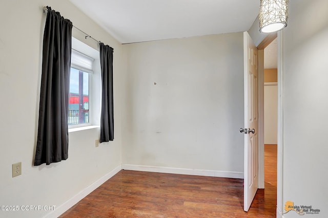 empty room featuring dark hardwood / wood-style flooring