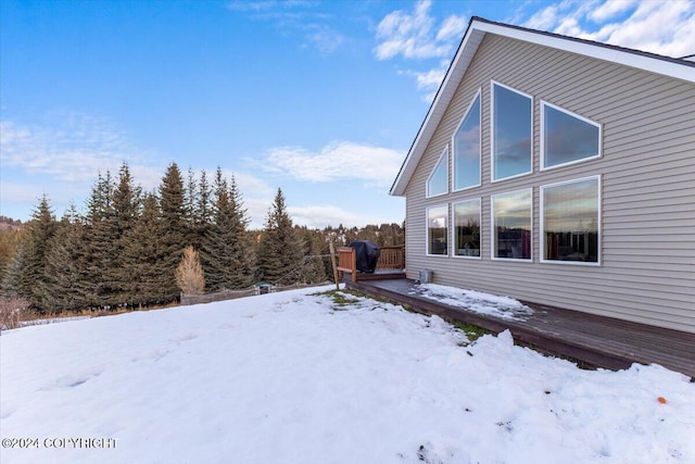 snow covered property featuring a deck