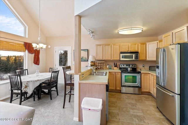 kitchen with sink, light brown cabinets, pendant lighting, and appliances with stainless steel finishes