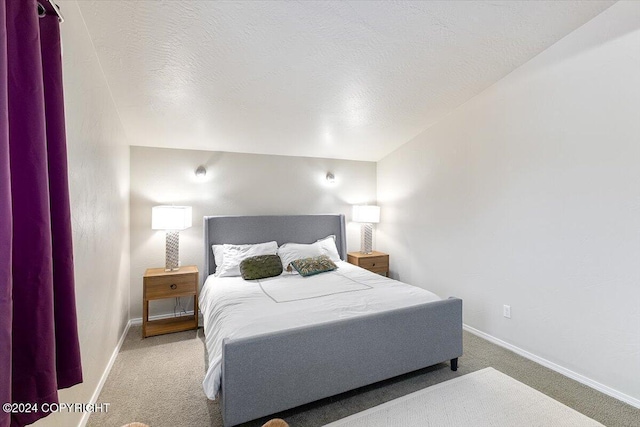 carpeted bedroom featuring a textured ceiling