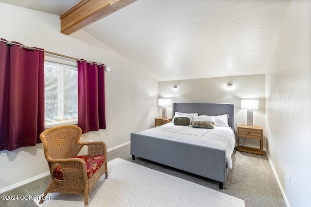 carpeted bedroom with a textured ceiling and vaulted ceiling with beams