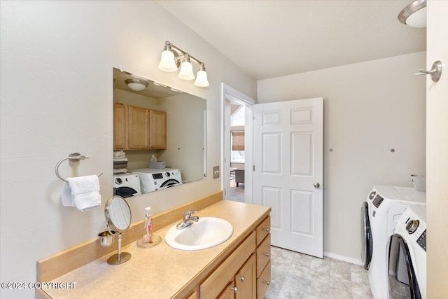 bathroom with washing machine and clothes dryer and vanity