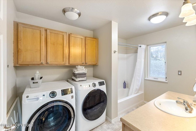 clothes washing area featuring washer and clothes dryer and sink