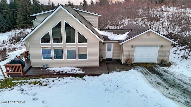 bungalow-style home featuring a garage and a deck