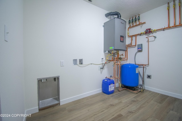 utility room featuring water heater