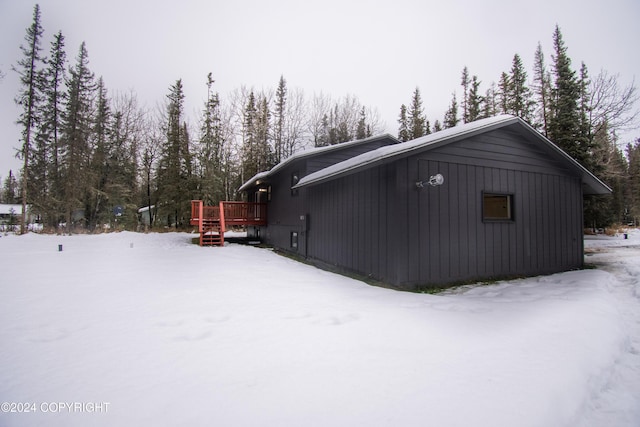 view of snow covered exterior featuring a wooden deck