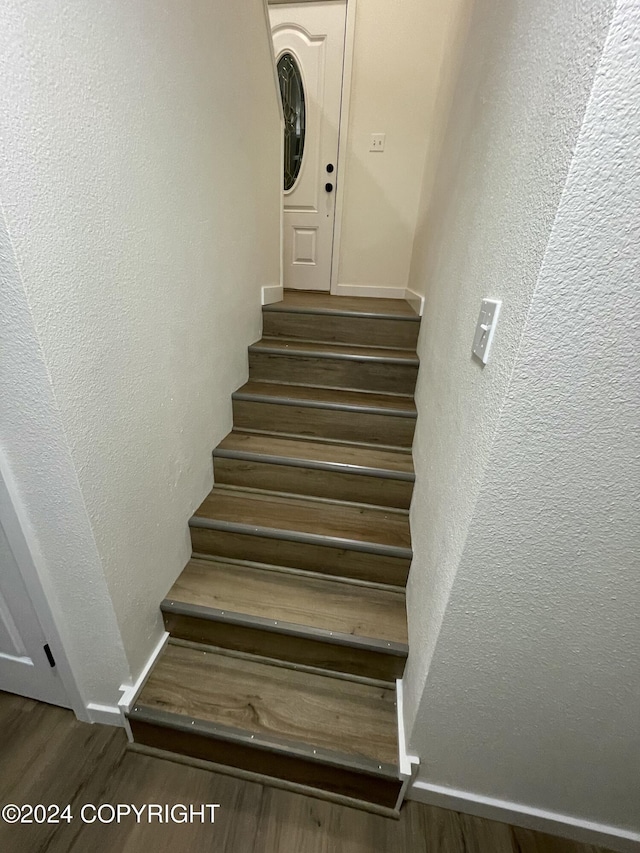 staircase with hardwood / wood-style flooring