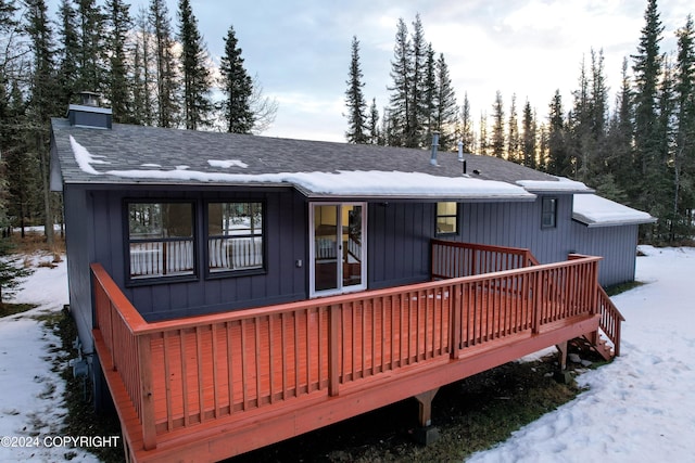 snow covered property featuring a deck