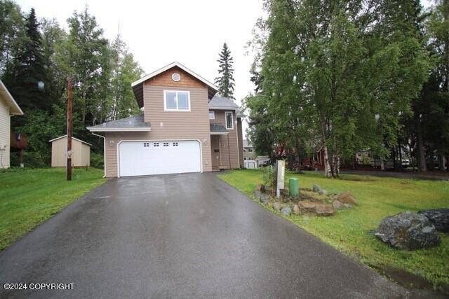 view of front facade with a front yard and a garage