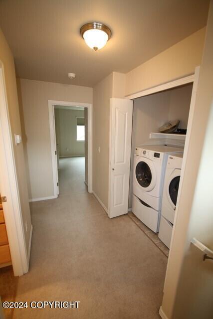 clothes washing area featuring separate washer and dryer