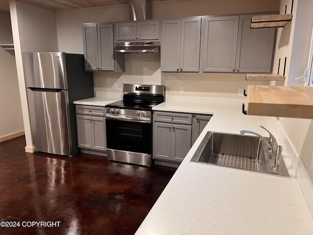 kitchen featuring appliances with stainless steel finishes, gray cabinets, and sink