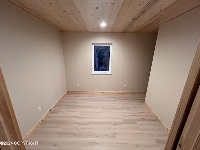 spare room with wooden ceiling and light wood-type flooring