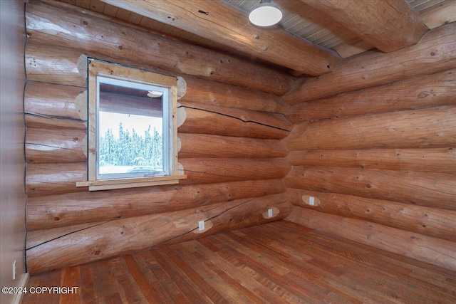 spare room featuring beam ceiling, wooden ceiling, and hardwood / wood-style flooring