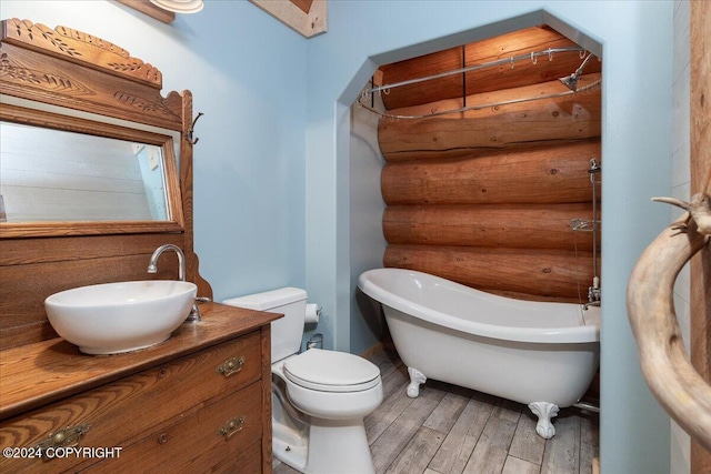 TL-215 Old Valdez Trl, Salcha, AK 99714 - bathroom with rustic walls, a freestanding tub, wood finished floors, and vanity