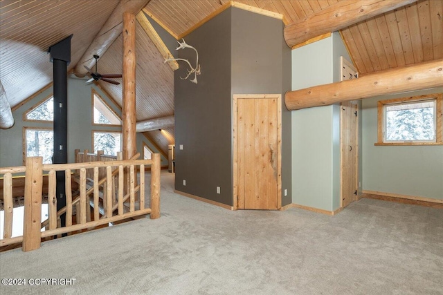 interior space with a healthy amount of sunlight, light colored carpet, ceiling fan, and wooden ceiling