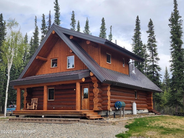 TL-215 Old Valdez Trl, Salcha, AK 99714 - view of front of home featuring log exterior, a porch, and a metal roof
