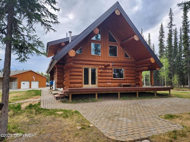 TL-215 Old Valdez Trl, Salcha, AK 99714 - rear view of house featuring log exterior, a garage, and an outdoor structure