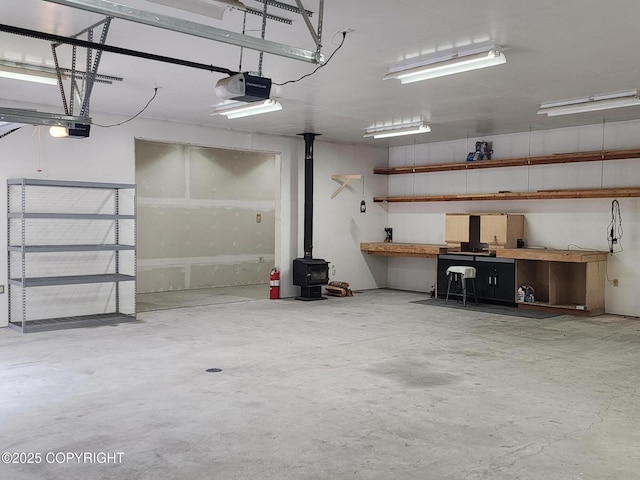 TL-215 Old Valdez Trl, Salcha, AK 99714 - garage featuring a garage door opener, a wood stove, and a workshop area
