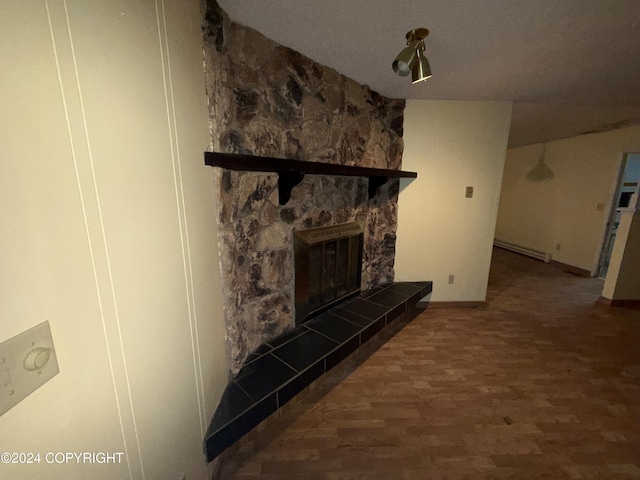 9231 Campbell Ter, Anchorage, AK 99515 - detailed view of wood finished floors, a large fireplace, and baseboard heating