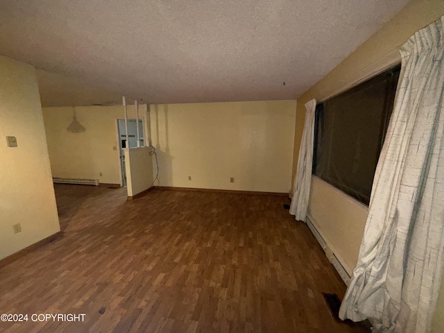 9231 Campbell Ter, Anchorage, AK 99515 - spare room with a baseboard radiator, wood finished floors, and a textured ceiling