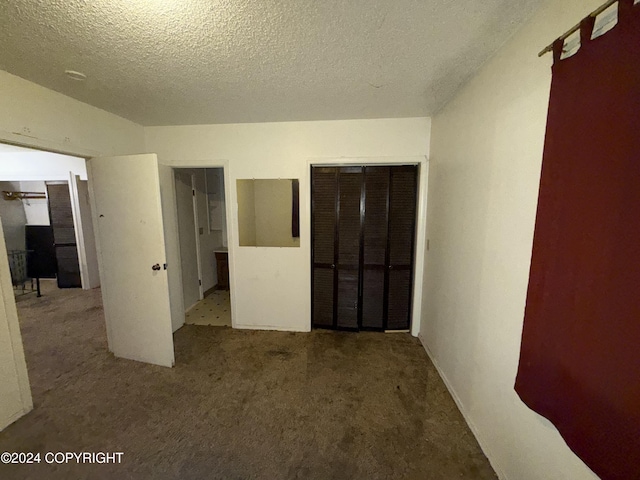 9231 Campbell Ter, Anchorage, AK 99515 - unfurnished bedroom featuring carpet floors, a textured ceiling, and a closet