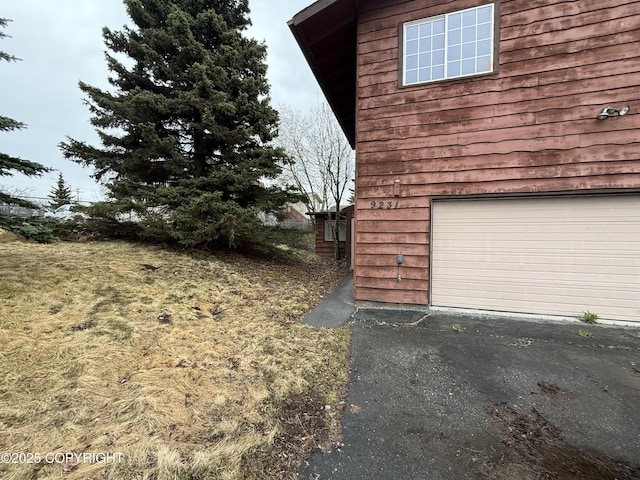 9231 Campbell Ter, Anchorage, AK 99515 - view of home's exterior featuring an attached garage and asphalt driveway