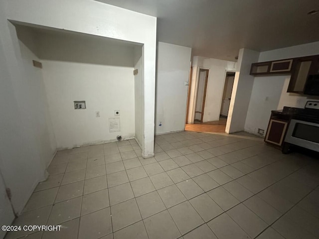 interior space with light tile patterned floors and washer hookup