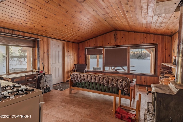 bedroom with wooden walls, wood ceiling, and vaulted ceiling