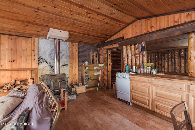 interior space with a wood stove, lofted ceiling, wooden walls, wood ceiling, and white gas range oven