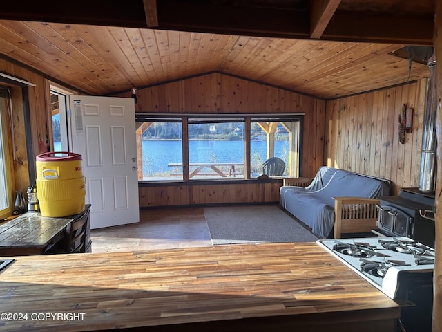 interior space with a water view, vaulted ceiling, and wooden ceiling