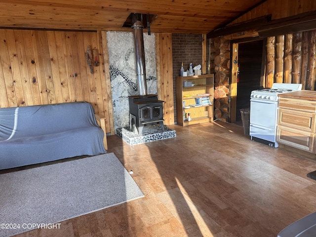 living room with vaulted ceiling, a wood stove, dark wood-type flooring, and wooden ceiling