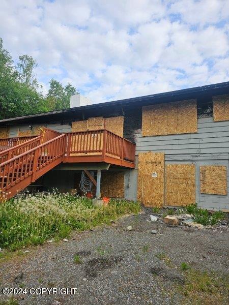 rear view of house with a wooden deck