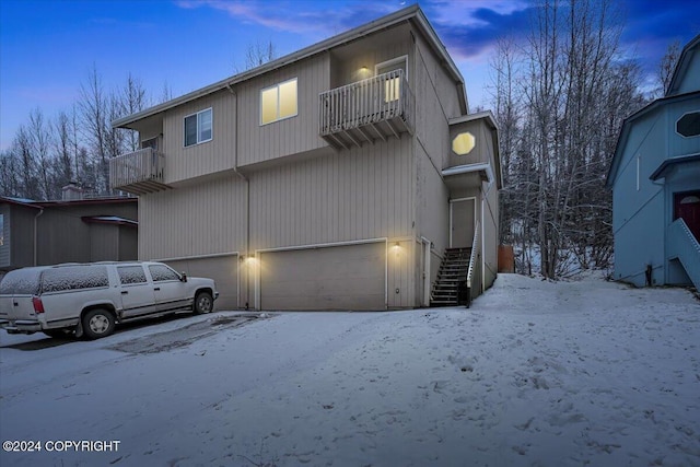 view of front of house featuring a balcony and a garage