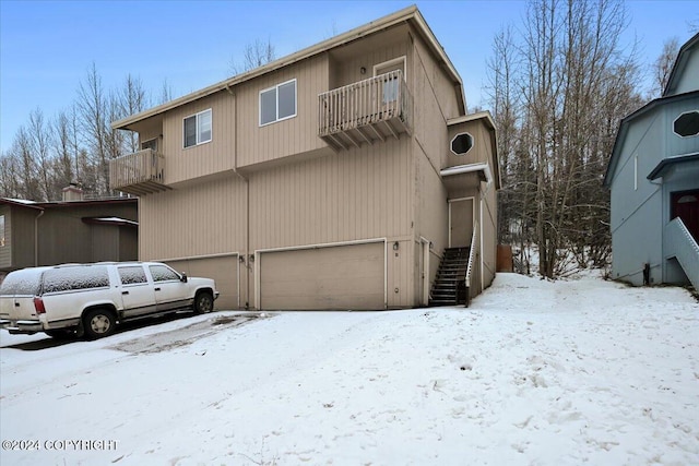 exterior space with a balcony and a garage