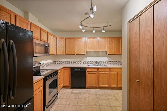 kitchen with sink, black appliances, and track lighting