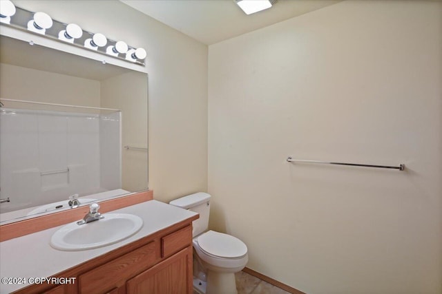 bathroom featuring vanity, toilet, and a shower